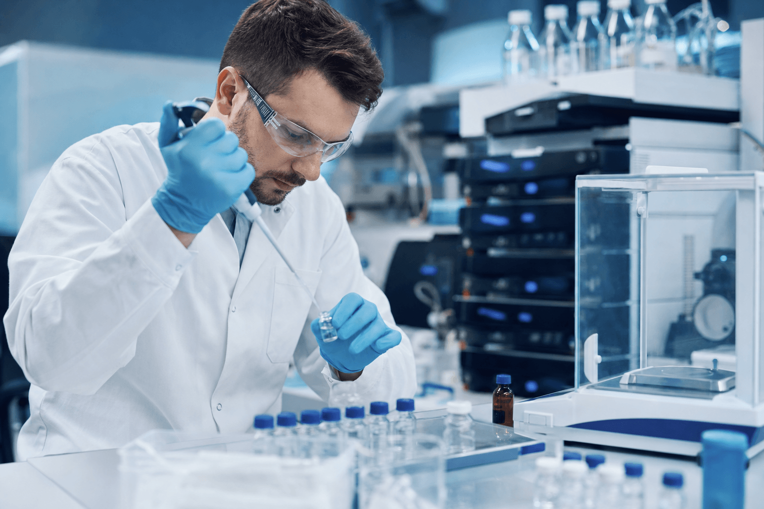 Scientist preparing a dosing formulation at an analytical chemistry lab bench